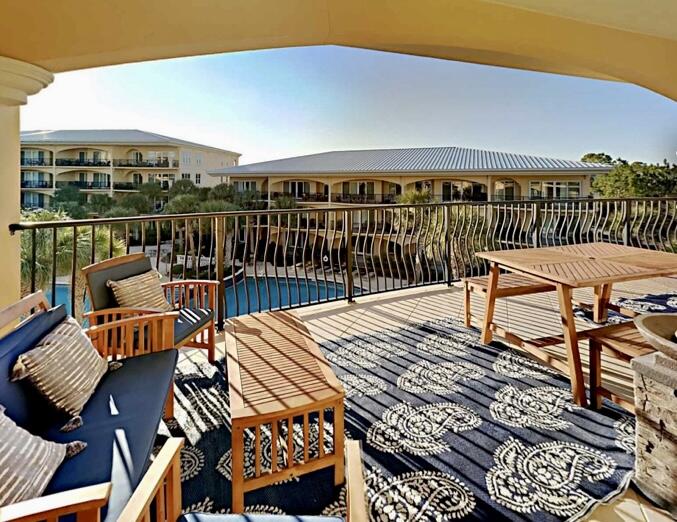 2421 West County Highway 30A, Unit E303 Santa Rosa Beach, FL 32459 - Photo 4 of 23 a balcony with chairs and wooden floor
