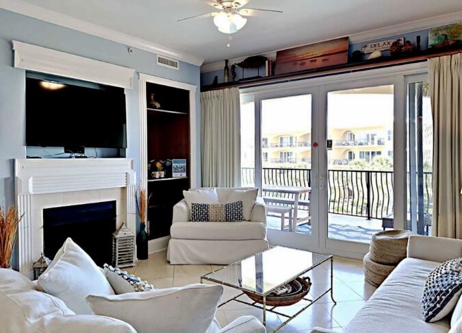 2421 West County Highway 30A, Unit E303 Santa Rosa Beach, FL 32459 - Photo 10 of 23 a living room with furniture a flat screen tv and a fireplace