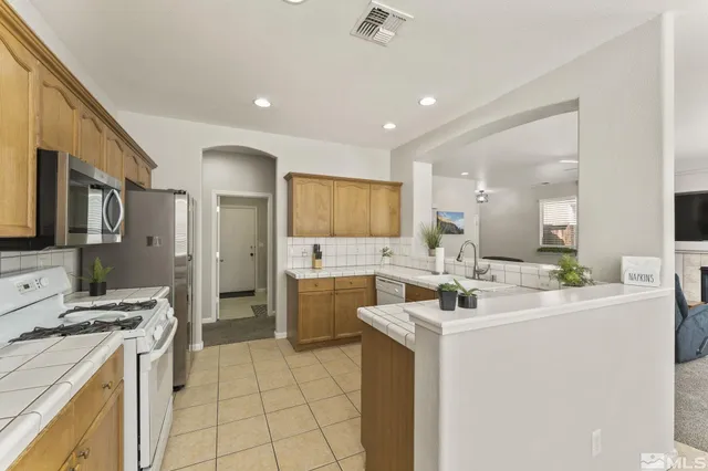 a kitchen with a sink stove and refrigerator