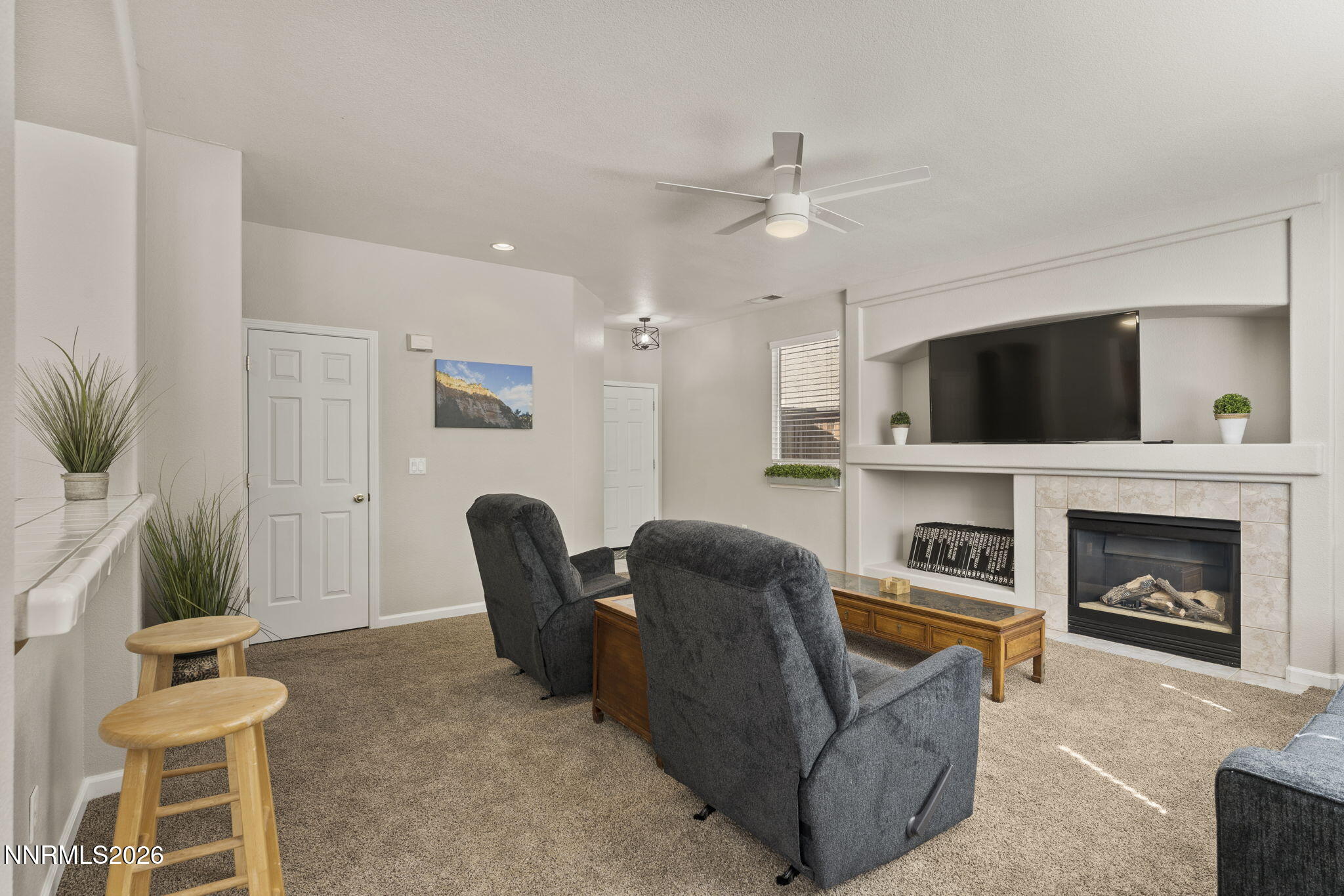 10640 Arbor Way Reno, NV 89521 - Photo 12 of 36 a living room with furniture a fireplace and a flat screen tv