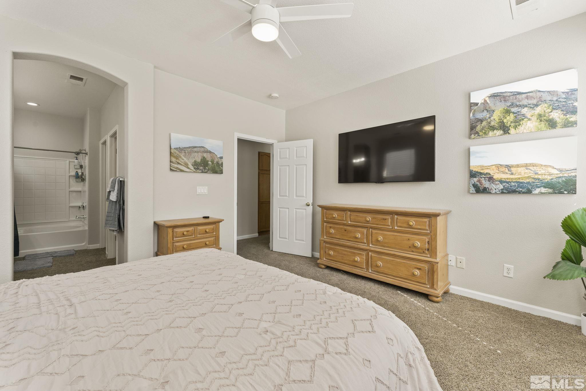 10640 Arbor Way Reno, NV 89521 - Photo 15 of 37 a bedroom with a bed and a flat screen tv in it