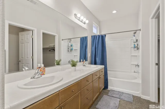a bathroom with a sink double vanity and a mirror