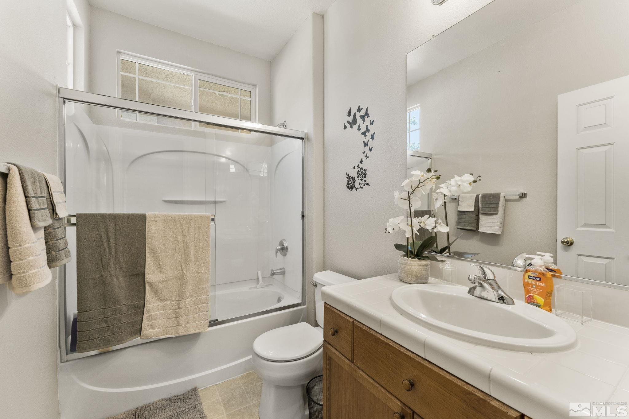10640 Arbor Way Reno, NV 89521 - Photo 22 of 37 a bathroom with a sink toilet and shower