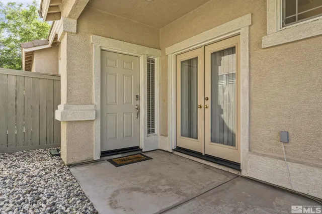a view of backyard with table and chairs and a large tree