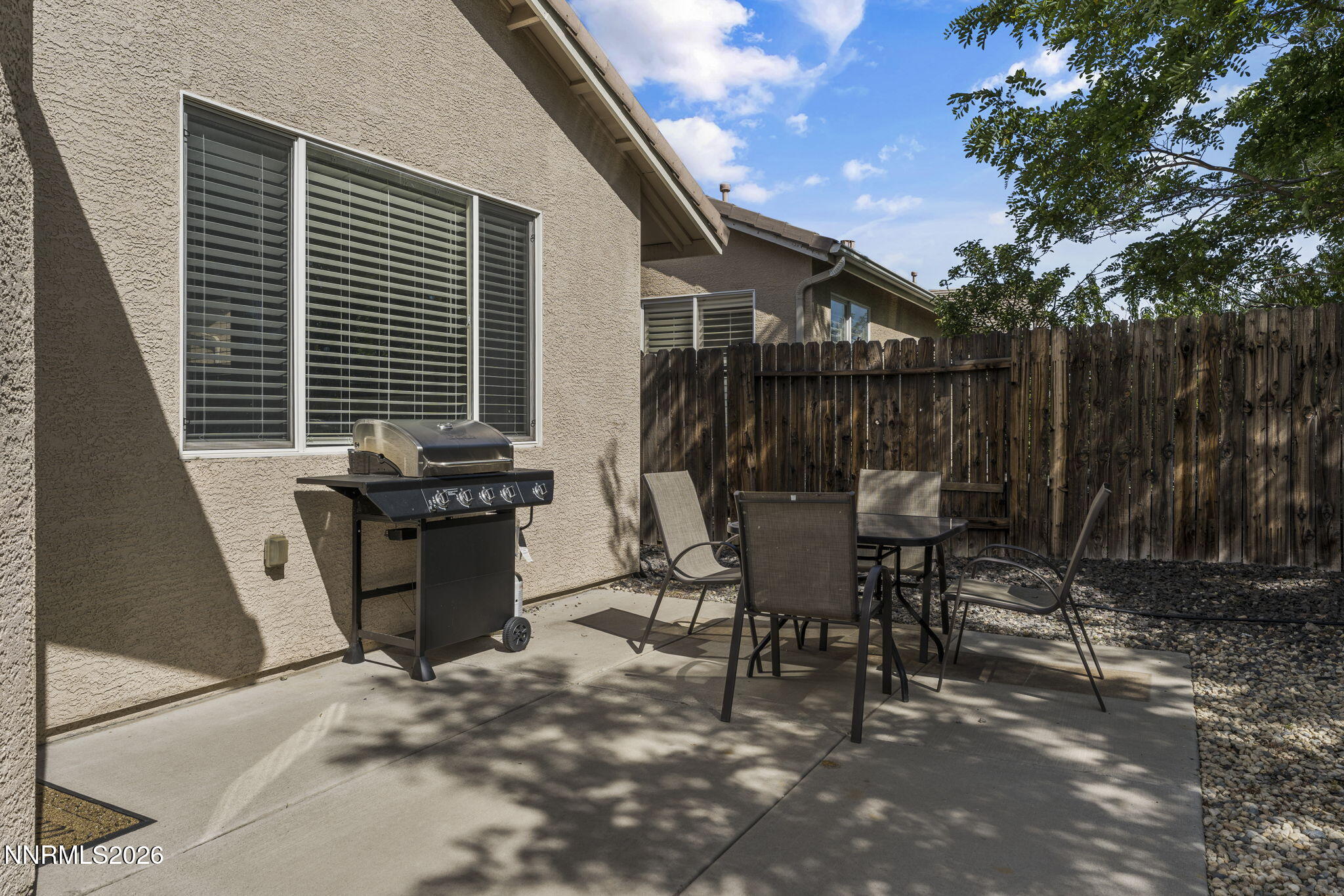 10640 Arbor Way Reno, NV 89521 - Photo 28 of 36 a view of a patio with table and chairs with wooden fence and plants