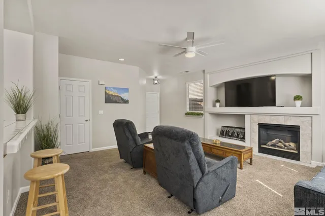 a living room with furniture a fireplace and a flat screen tv