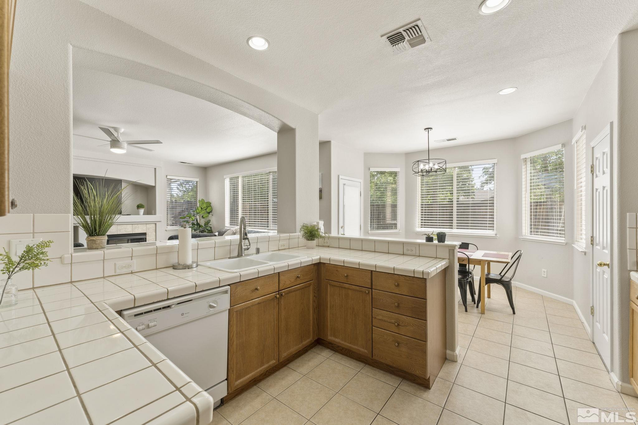 10640 Arbor Way Reno, NV 89521 - Photo 9 of 37 a kitchen with a sink and chairs