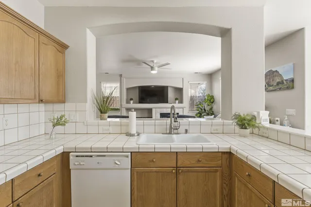 a kitchen with a sink and a wooden floor