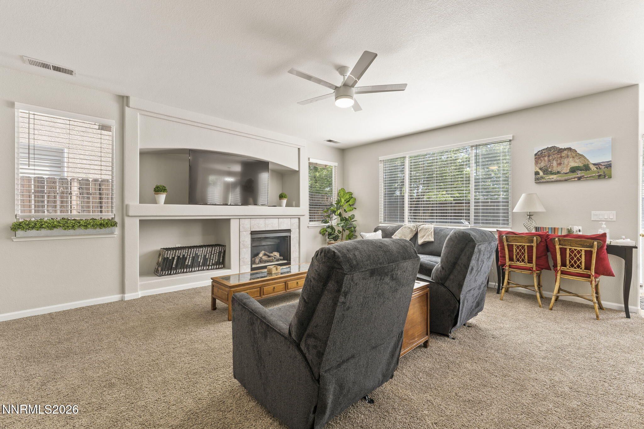 10640 Arbor Way Reno, NV 89521 - Photo 10 of 36 a living room with furniture a fireplace and a floor to ceiling window