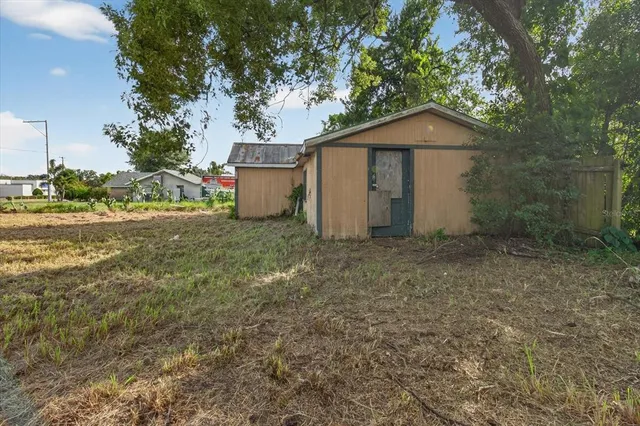 a view of a house with a yard and garage