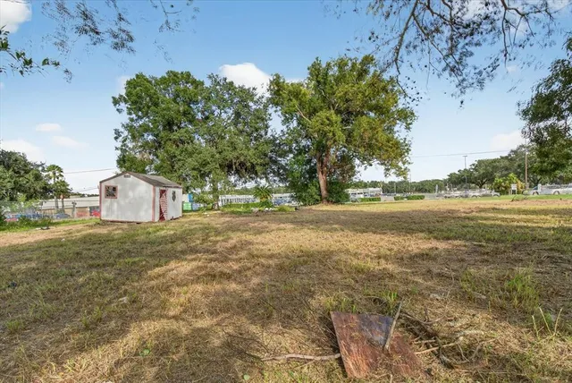 a backyard of a house with a yard and outdoor seating