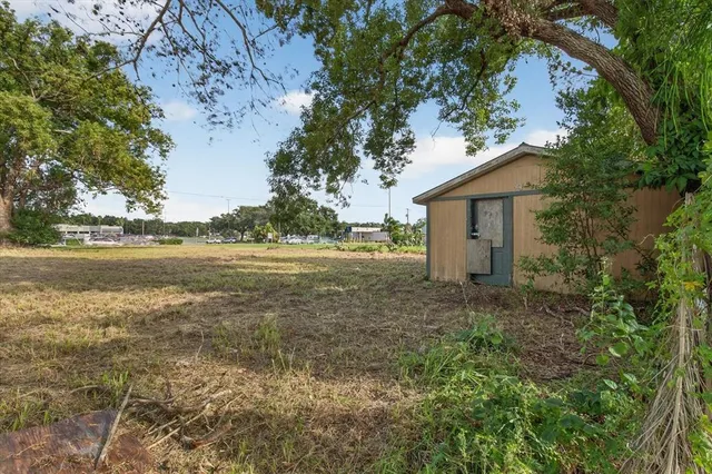 a backyard of a house with table and chairs