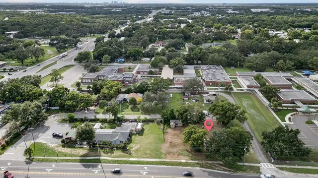 an aerial view of a house with yard swimming pool and outdoor seating