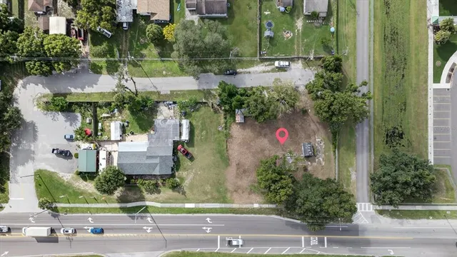 an aerial view of a house with a yard