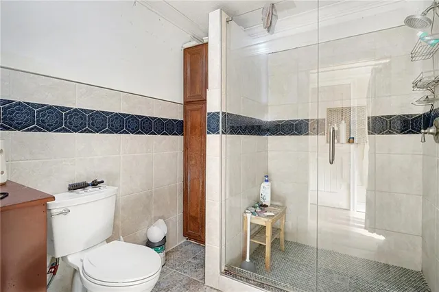 a white toilet sitting next to a bathroom sink