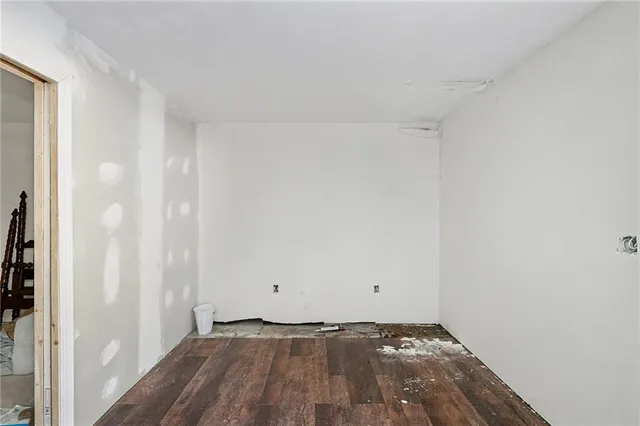a view of an empty room and wooden floor
