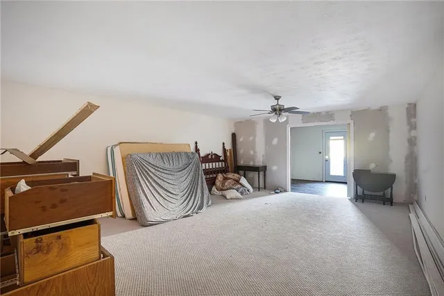a spacious bedroom with a bed and a chandelier