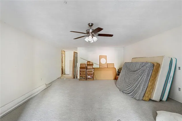 a living room with furniture and a ceiling fan