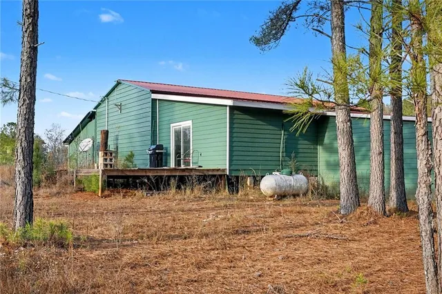 a backyard of a house with table and chairs