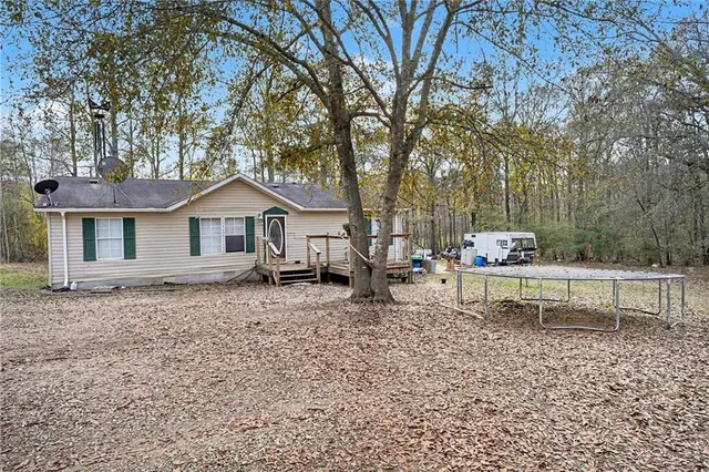 a view of a house with a yard and sitting area