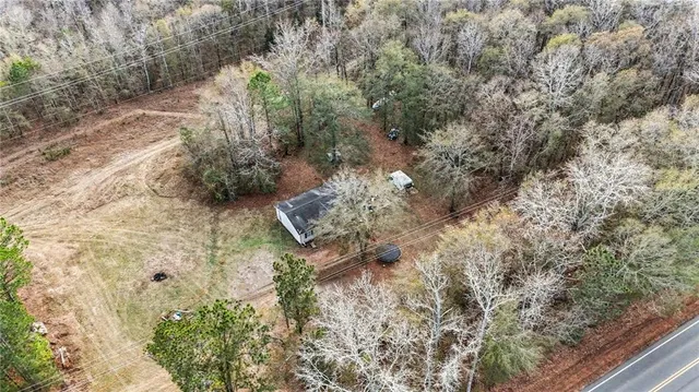 a view of a yard with large trees
