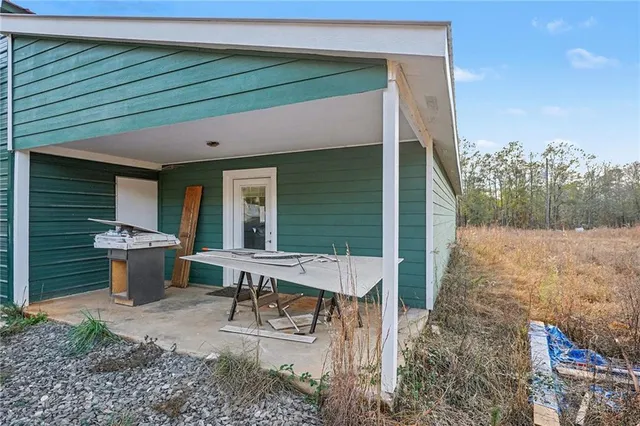 a view of house with backyard and outdoor seating