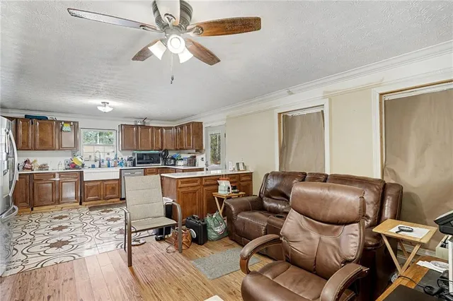 a room with furniture or wooden floor and a view of kitchen