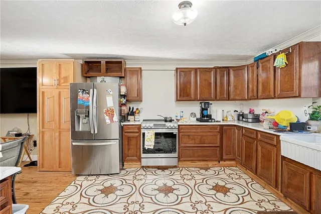a kitchen with stainless steel appliances granite countertop a refrigerator sink and cabinets