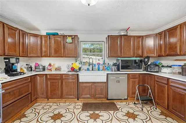 a kitchen with granite countertop a sink cabinets and window