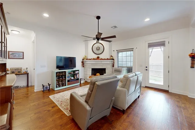 a living room with furniture a fireplace and a flat screen tv