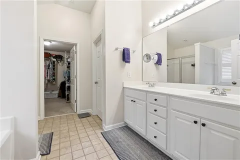 a spacious bathroom with a double vanity sink mirror and