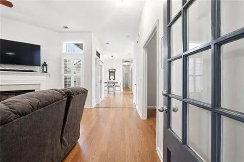 a living room with furniture wooden floor and a flat screen tv