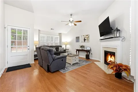 a living room with furniture fireplace and flat screen tv