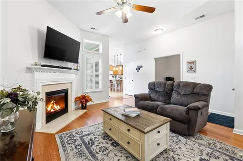 a living room with furniture fireplace and flat screen tv