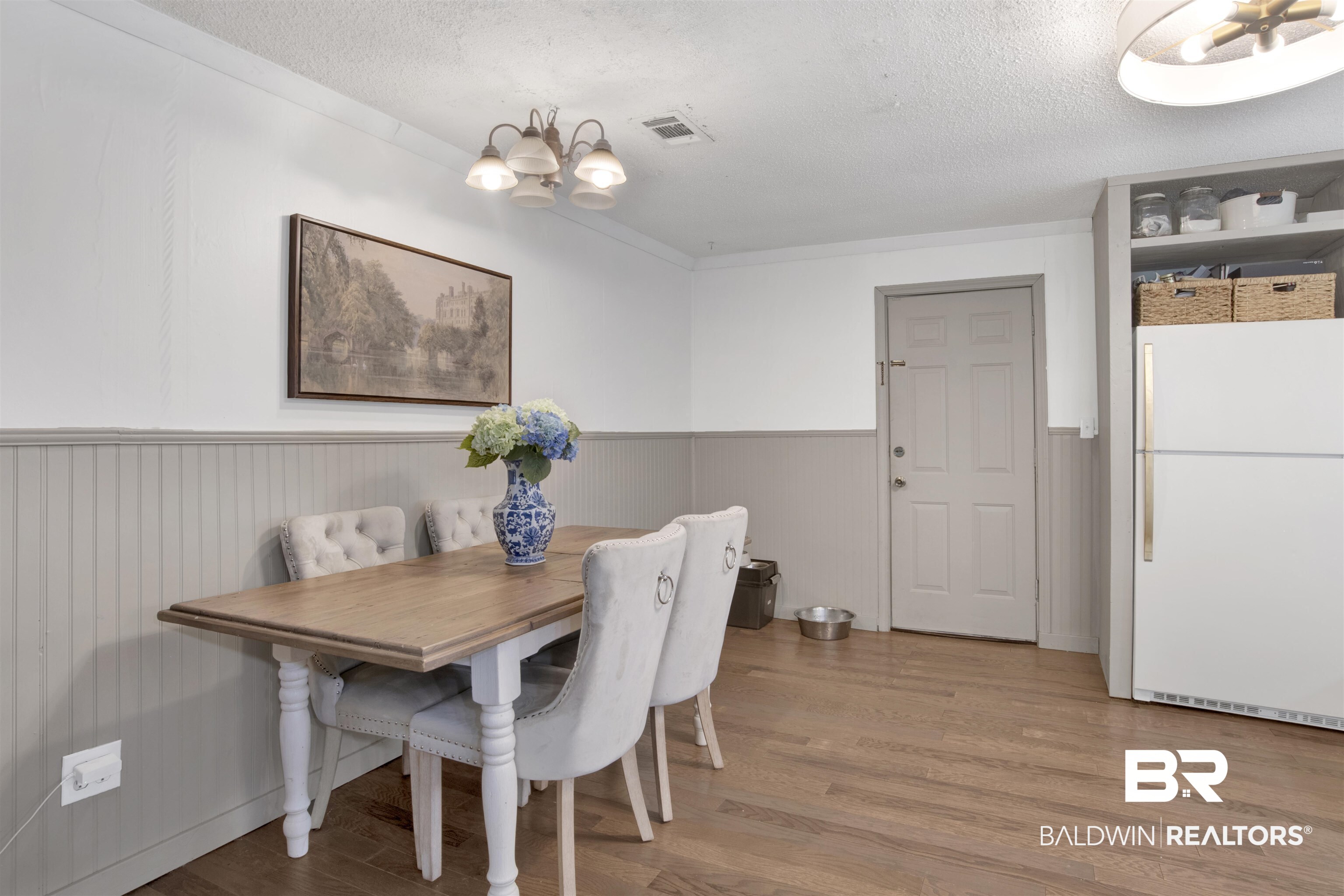 4265 Greaves Road Eight Mile, AL 36613 - Photo 11 of 34 Dining space with wainscoting, a chandelier, a textured ceiling, and light wood finished floors
