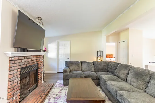 a living room with furniture a flat screen tv and a fireplace