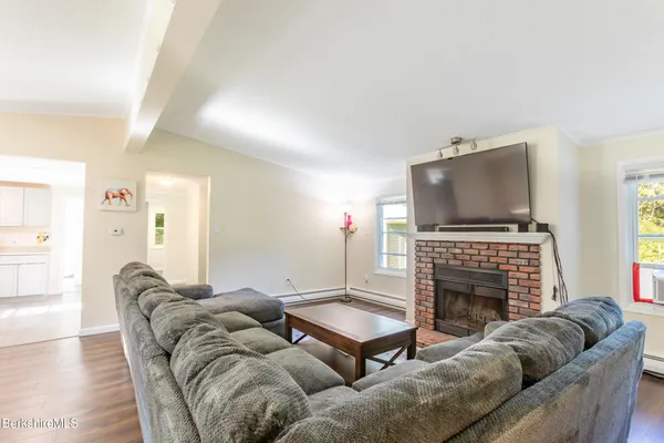 a living room with furniture a flat screen tv and a fireplace