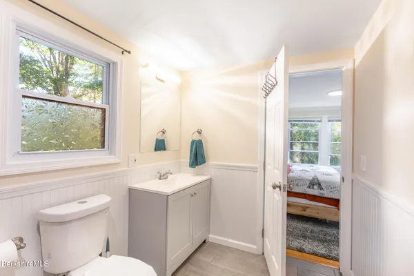 a bathroom with a sink a toilet and a window