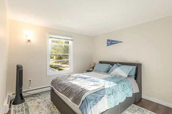 a large bed sitting in a bedroom next to a window