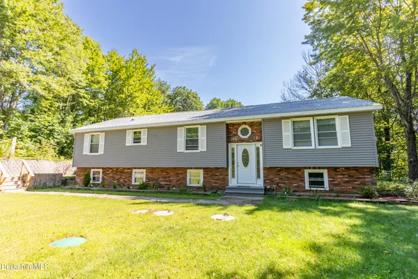 a view of a house with a swimming pool with a yard