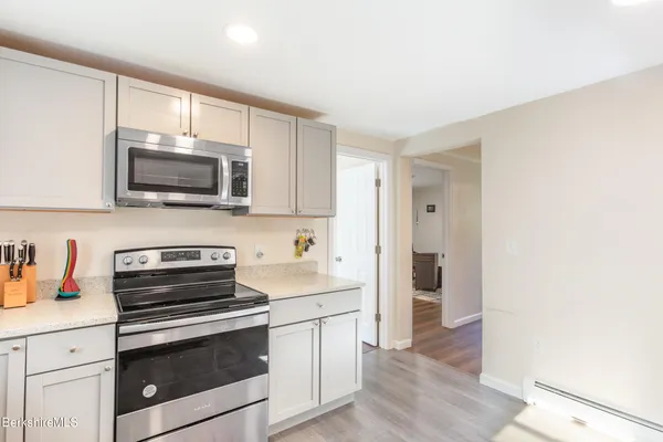a kitchen with stainless steel appliances a stove microwave and sink