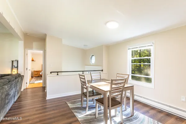 a view of a dining room with furniture and wooden floor