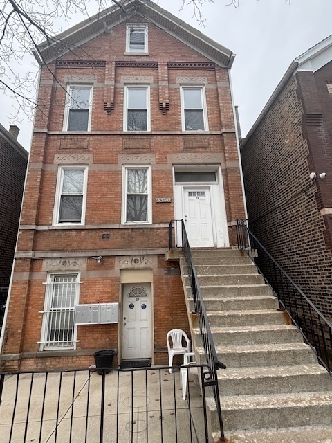 3340 South Carpenter Street, Unit 1R Chicago, IL 60608 - Photo 1 of 7 a front view of a house with stairs