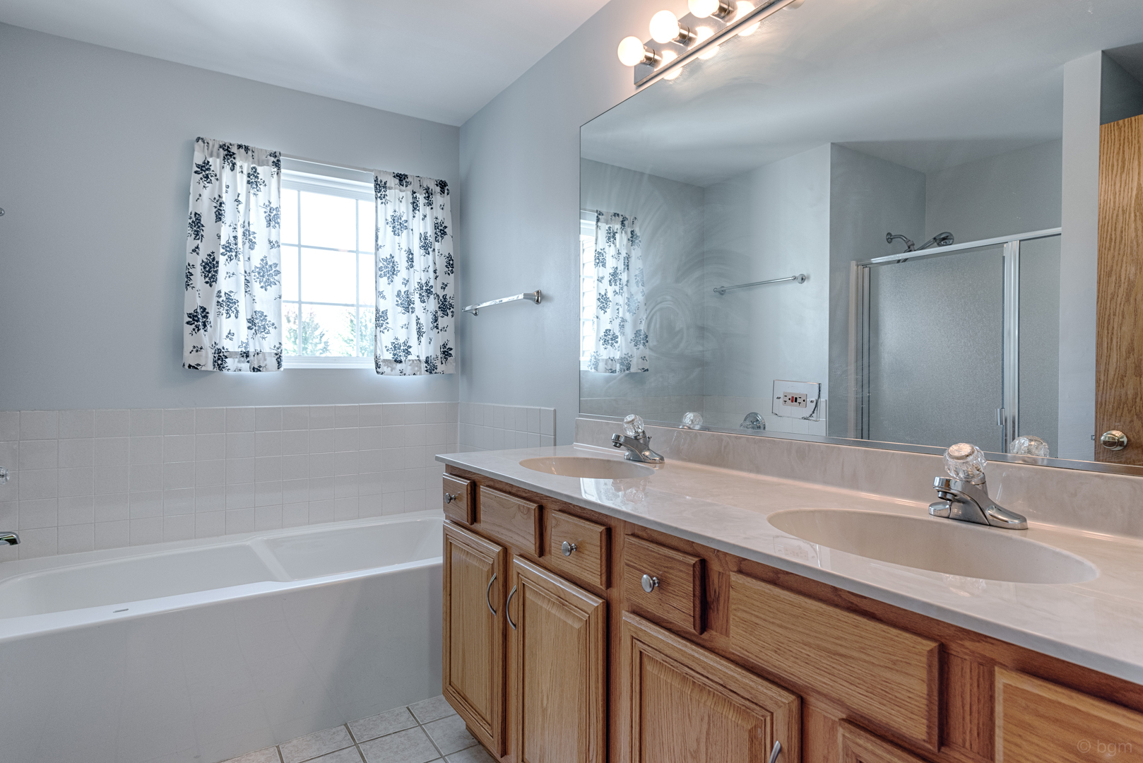 3261 Cool Springs Court Naperville, IL 60564 - Photo 13 of 25 a bathroom with a sink double vanity granite tub shower and a mirror