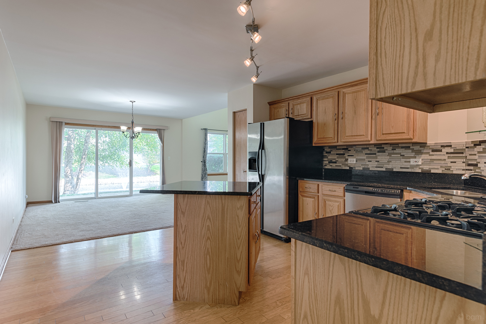 3261 Cool Springs Court Naperville, IL 60564 - Photo 3 of 25 a kitchen with stainless steel appliances granite countertop a refrigerator a stove and a sink with wooden floor