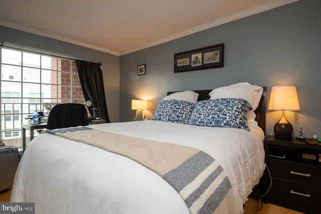 a bedroom with a bed and a lamp