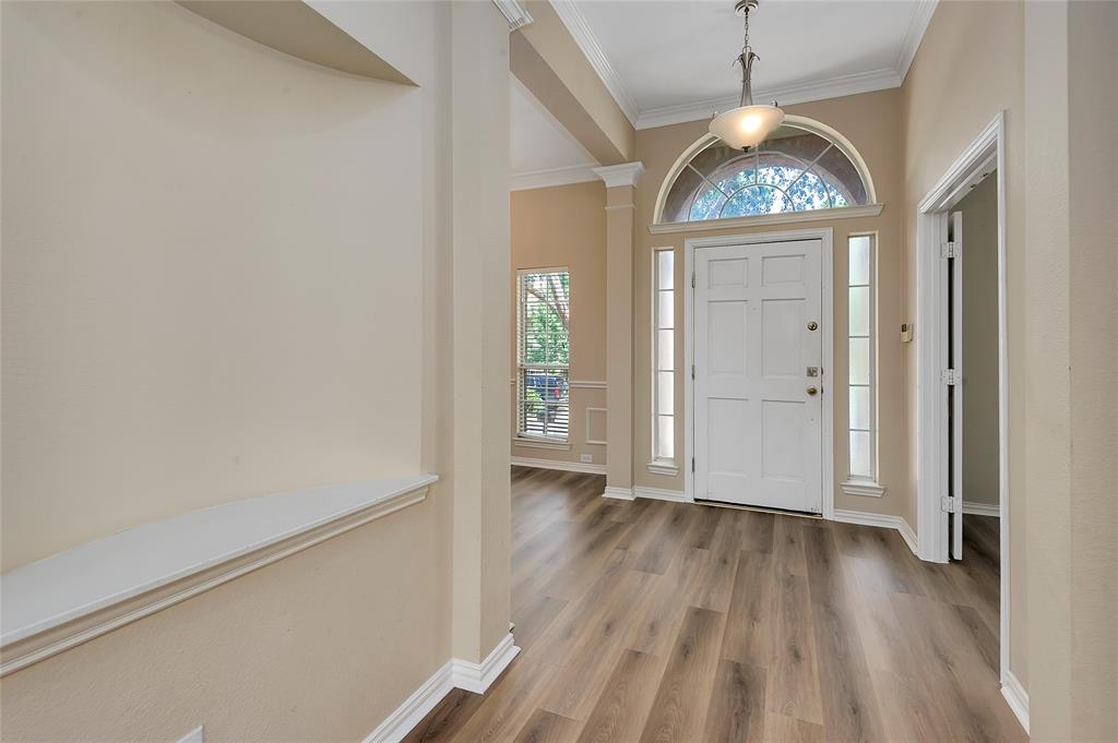 1404 Ranch Hill Drive Irving, TX 75063 - Photo 4 of 31 Foyer featuring a white paneled front door, an arched transom window, and side lite windows