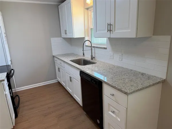 a kitchen with a sink cabinets and window