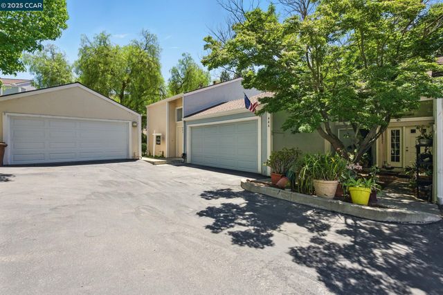 a view of a house with a yard and sitting area
