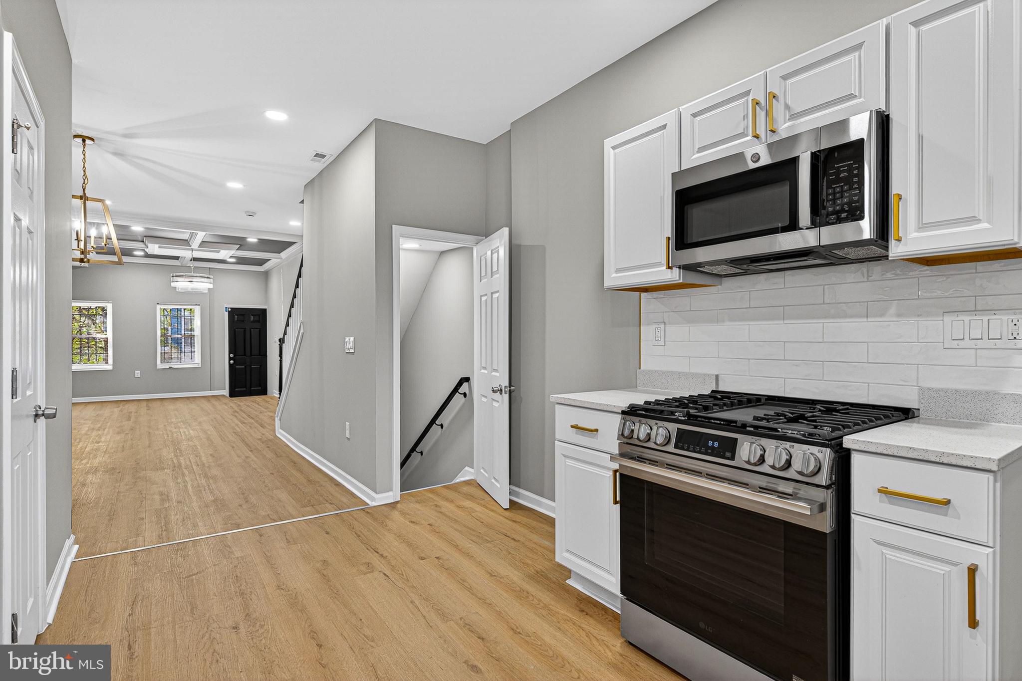 a kitchen with stainless steel appliances kitchen island granite countertop a stove and a microwave
